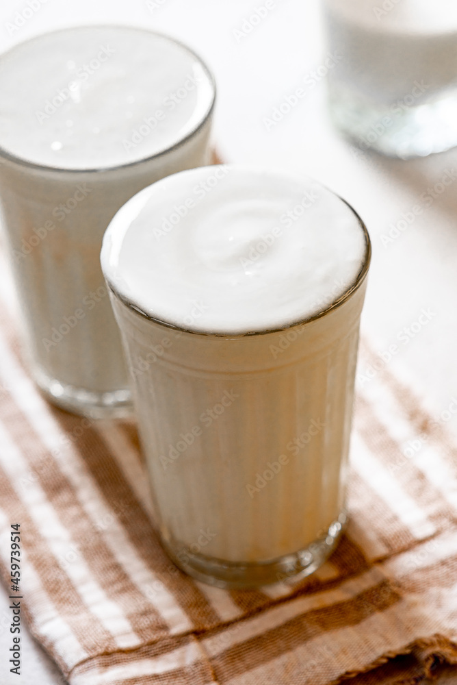 Homemade kefir or yogurt in glasses close-up. Fermented milk drink, kefir with prebiotics. Healthy food or drink. Homemade kefir or yogurt in glasses close-up. Fermented milk drink, kefir with prebiotics. Healthy food or drink.