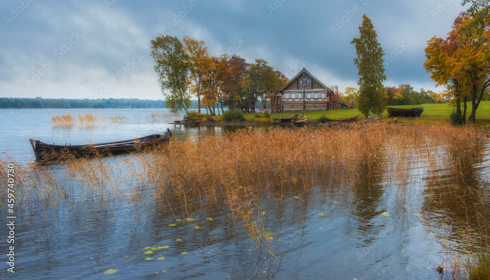 A village house made of logs in the Kizhi Museum Reserve in the north of Russia on Lake Onega with docks and a pier.