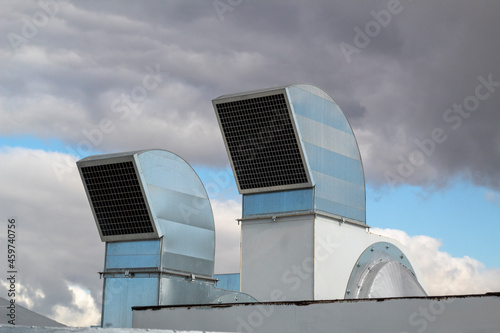 Ventilation and air conditioning system installed on the roof of an office building, galvanized elements of air ducts.