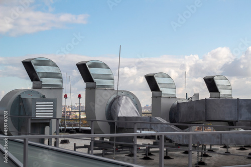 Ventilation and air conditioning system installed on the roof of an office building, galvanized elements of air ducts.