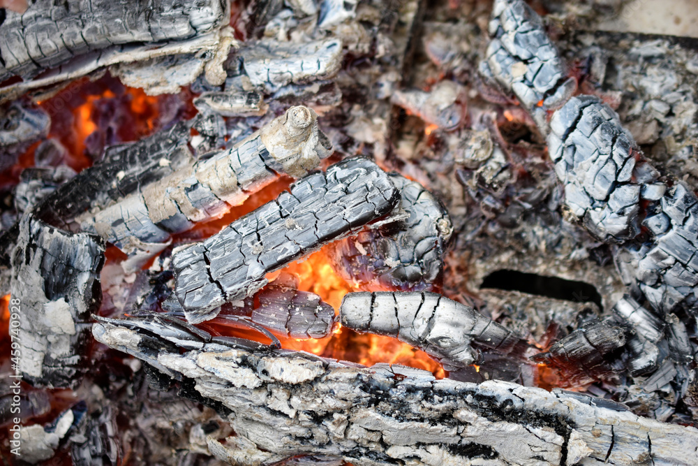 Burning coals in a fire with flames Burning coals in a fire with flames