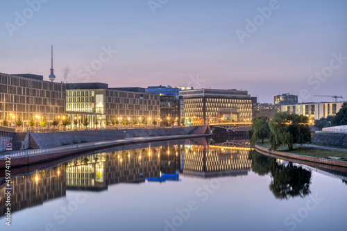 Modern office buildings at the river Spree in Berlin at dawn with the famous TV Tower in the back © elxeneize