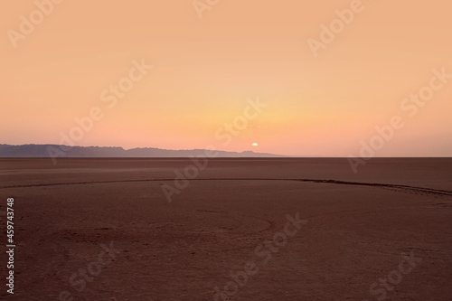 Beautiful sunrise over a salt lake in the Sahara Desert.
