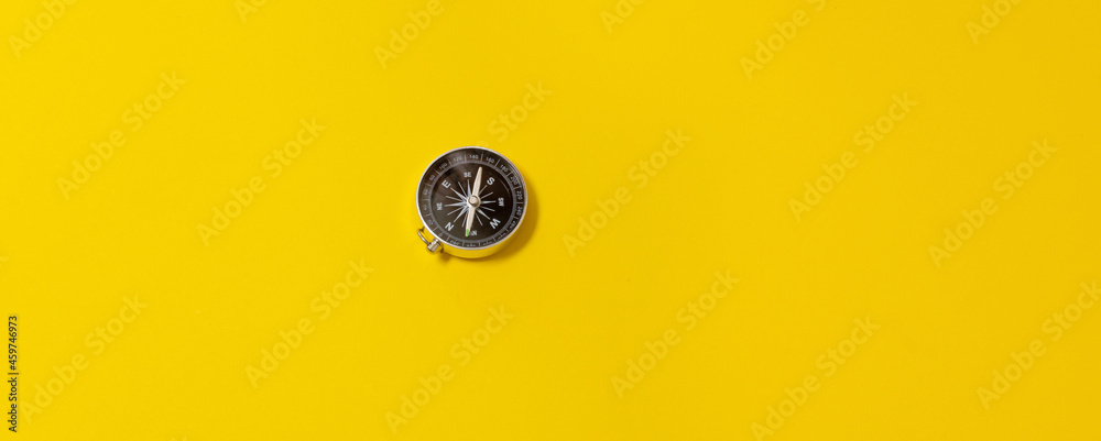 Journey, adventure lifestyle. Road to home. Trip. Compass on a yellow background with copy space Journey, adventure lifestyle. Road to home. Trip. Compass on a yellow background with copy space