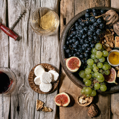 Wine appetizers with different grapes and wine