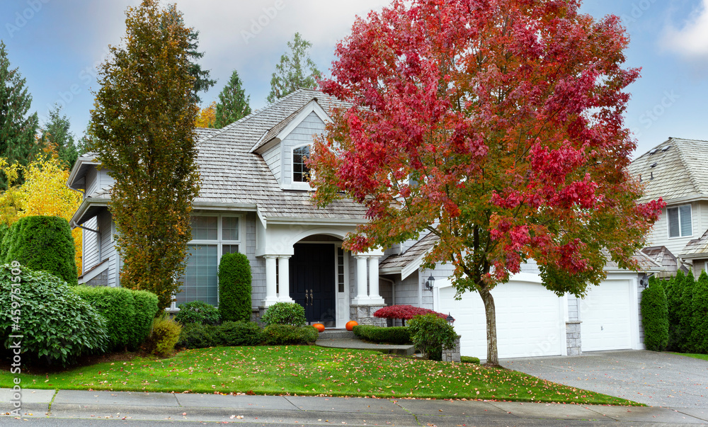 Suburban home during early autumn as leaves turn yellow and red Suburban home during early autumn as leaves turn yellow and red