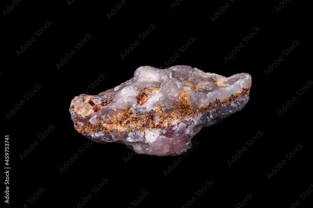 Macro pink Smithsonite mineral stone on microcline on black background