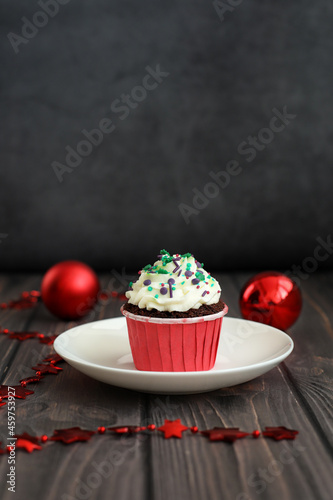 Cupcake with New Years decor on a dark background. Concept food, holidays, happy new year