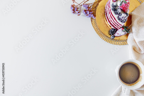 Breakfast composition with red velvet cake and a cup of milk and coffee on white background. Flat lay, top view.