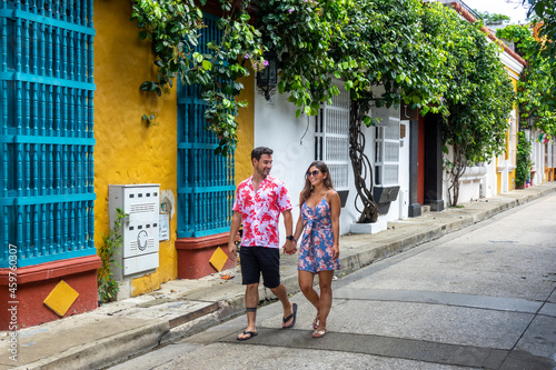 Beautiful tourist couple walking in the colorful streets of Cartagena de Indias, Colombia