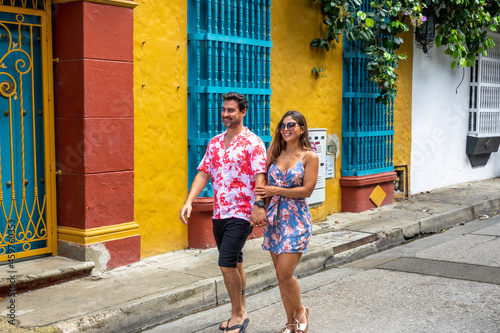 Beautiful tourist couple walking in the colorful streets of Cartagena de Indias, Colombia