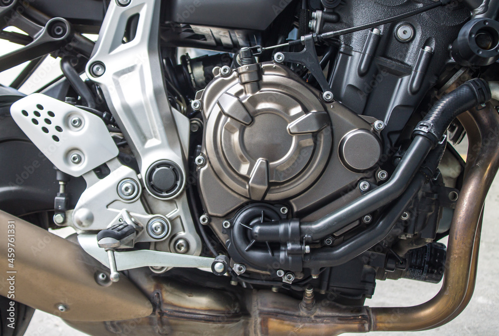 Obraz premium Titanium color motorcycle engine, black gear cooling line. brown muffler