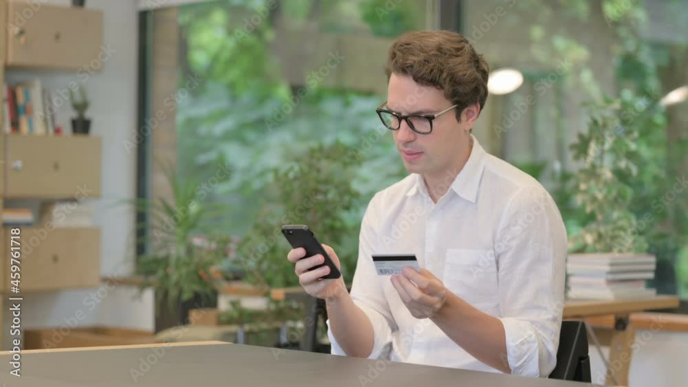 Young Man making Online Payment on Smartphone Young Man making Online Payment on Smartphone