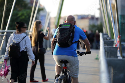 Mężczyzna jedzie na rowerze po moście we Wrocławiu.