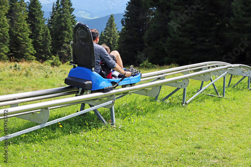 Fototapete Father and son enjoying a summer fun roller alpine coaster ride