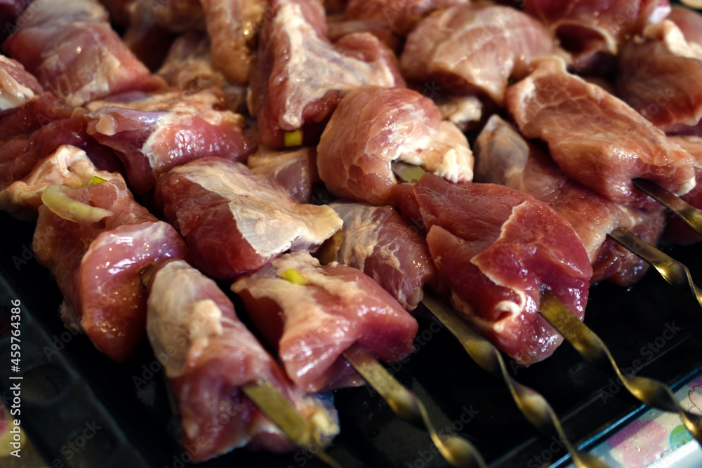 Raw pork meat on a barbecue skewer Raw pork meat on a barbecue skewer