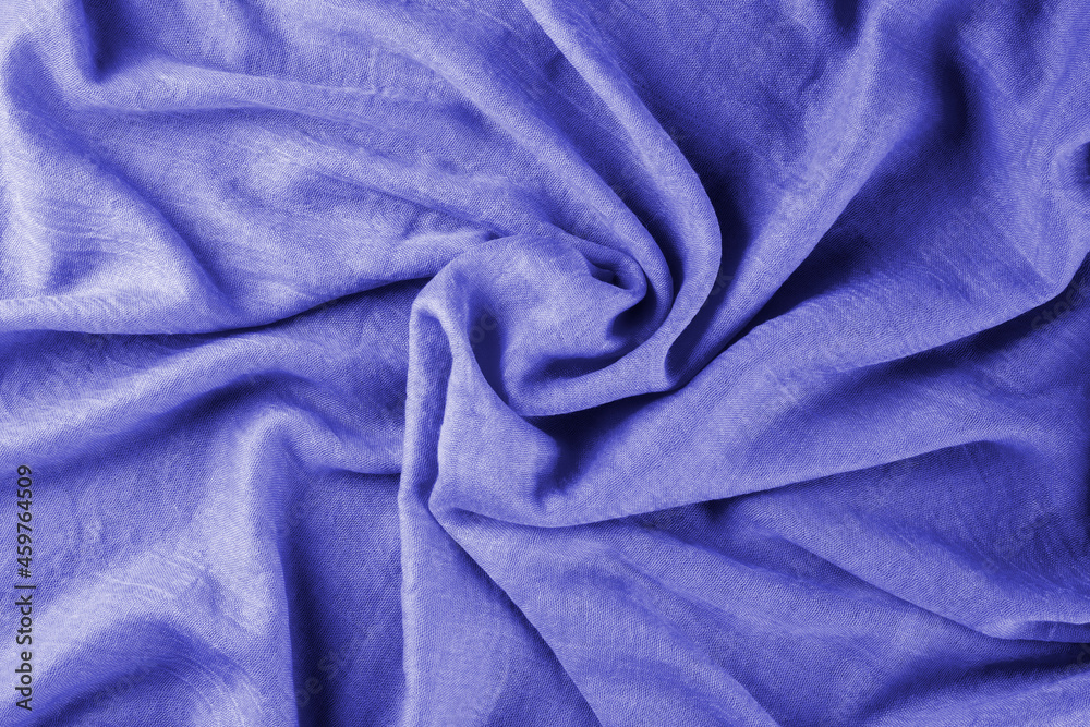 Close-up of bright yellow draped lightweight fabric as background. Selective focus.