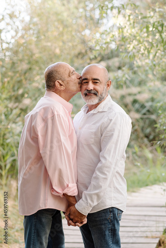 Lovely middle-aged gay couple enjoying romantic moments together during a date. LGBT pride concept.