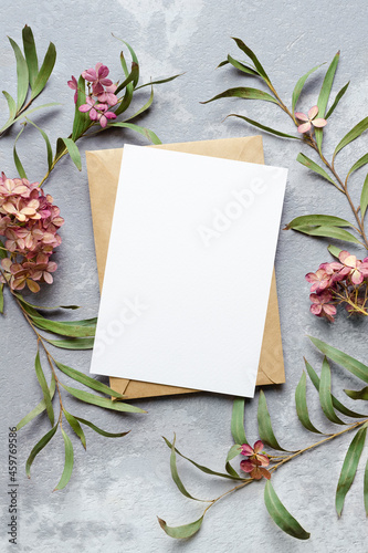 Wedding invitation or greeting card mockup with eucalyptus and hydrangea plants decorations.