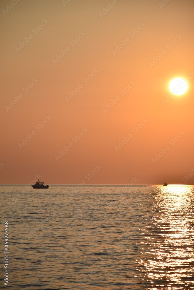 Boat trolling Lake Michigan at sunset