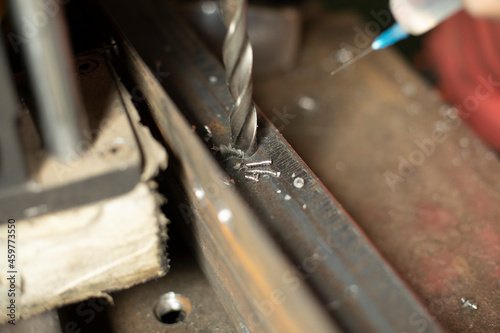 Drill inside the steel. Making a hole in the metal. Heating the drill.