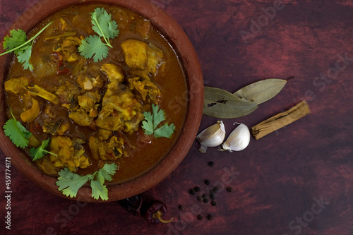 Selective focused, Chicken curry or masala or country chicken kuzhambu Tamilnadu style , chicken curry using fried coconut oil in traditional way and served in a mud pot. photo