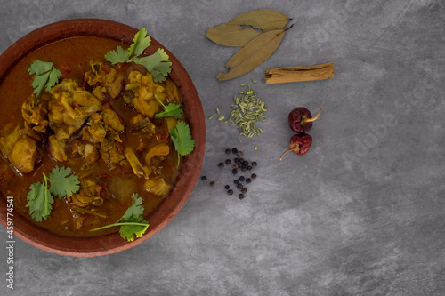 Selective focused, Chicken curry or masala or country chicken kuzhambu Tamilnadu style , chicken curry using fried coconut oil in traditional way and served in a mud pot. photo