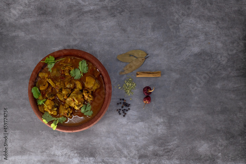 Selective focused, Chicken curry or masala or country chicken kuzhambu Tamilnadu style , chicken curry using fried coconut oil in traditional way and served in a mud pot. photo