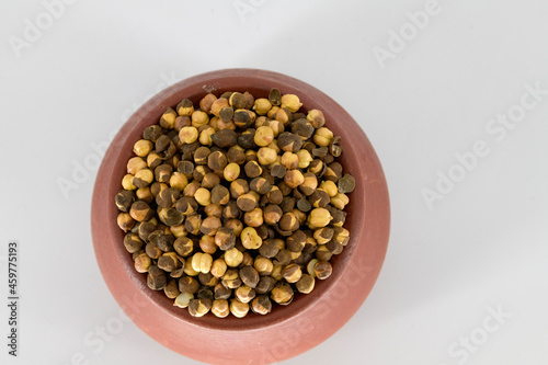 Selective focused Indian health snack called Varuth uppu kadalai , rosted chickpeas with salt on a isolated white background. Rosted without oil and very healthy daily snacks