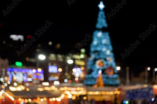 Blurred night landscape with a Christmas tree