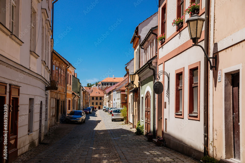 Trebic, Bohemia, Czech Republic, 06 July 2021: Narrow picturesque street with colorful buildings in historic center in medieval city, renaissance and baroque historical buildings at summer sunny day
