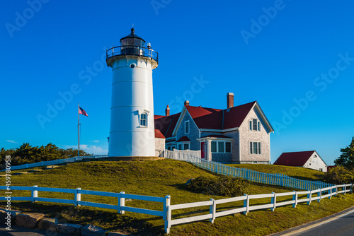 Knobska Light with red-roof keeper's house on the green hill at dawn