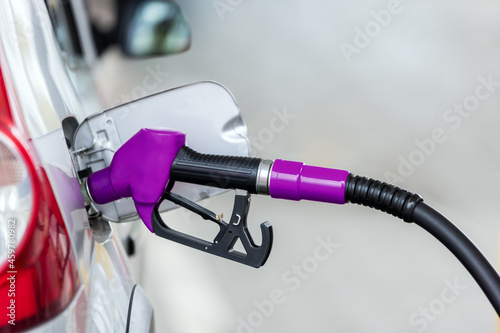 Принти на полотні Silver car refuelling at the gas station, the concept of fuel energy
