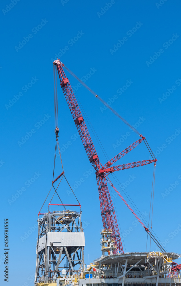 industrial crane lifting large machine parts.