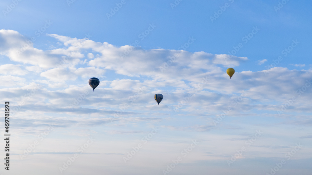 How to travel during quarantine. Hot air balloon. Colorful hot-air balloons flying over the fields How to travel during quarantine. Hot air balloon. Colorful hot-air balloons flying over the fields