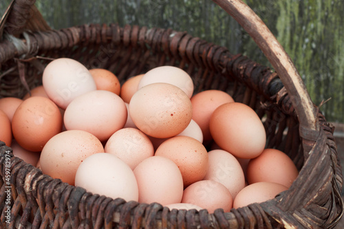 Basket of fresh brown eggs. Rural still life with chicken egg and wicker. Bio food for cooking.