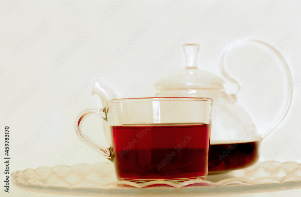 tea in a transparent mug with a teapot on a light background tea in a transparent mug with a teapot on a light background