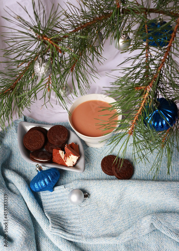 cup of tea with cookies and sweets under the christmas tree