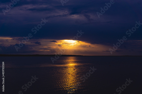 Golden Sunset In Storm Clouds Over Ocean Lake