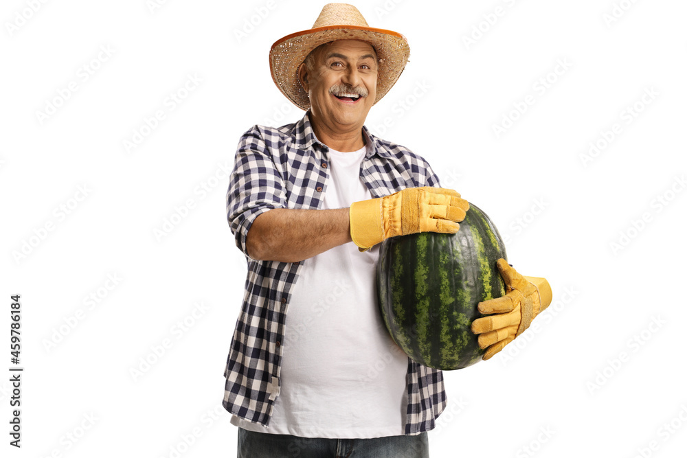 Cheerful farmer with a straw hat holding a big watermelon