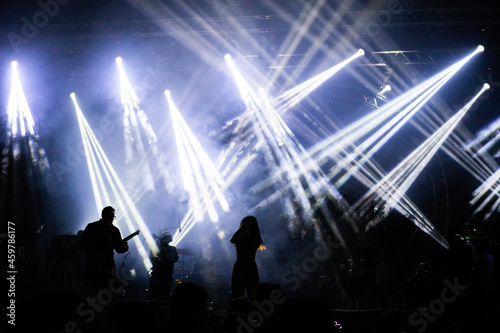 crowd at concert and silhouettes in stage lights