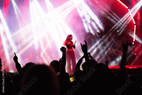 crowd at concert and silhouettes in stage lights