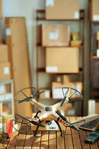 desk with parcels and drone in warehouse
