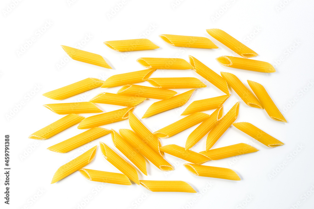 Fototapeta premium Raw uncooked Italian penne rigate pasta isolated on white background