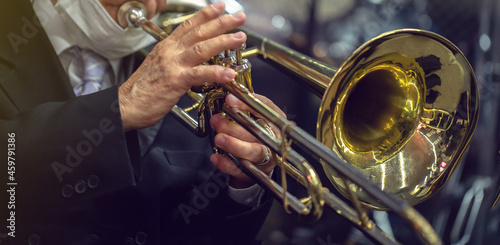 man playing the trombone. golden metal instrument detail. to use in banners or presentations