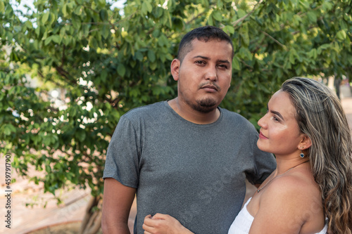 Hispanic couple standing in the park