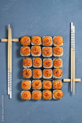 Traditional Japanese food - sushi, rolls and sauce on a dark background. Top view
