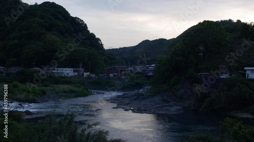 Koi nobori, carp-shaped flags waving on the river at the sunset time in Shuzenji, Shizuoka, Japan in May. photo