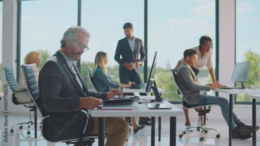 Group of various people working in office, typing on computer and discussing. Modern open space office interior. Group of various people working in office, typing on computer and discussing. Modern open space office interior.
