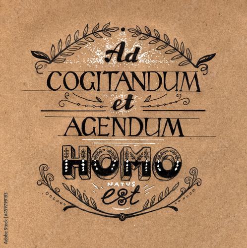 The Latin sentence "Human is born to think and act". Hand drawn lettering composition on craft paper. "Ad cogitandum et agendum..."